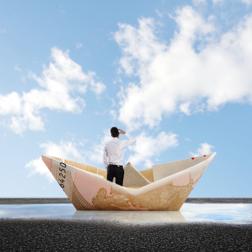 man into a bill boat on a puddle